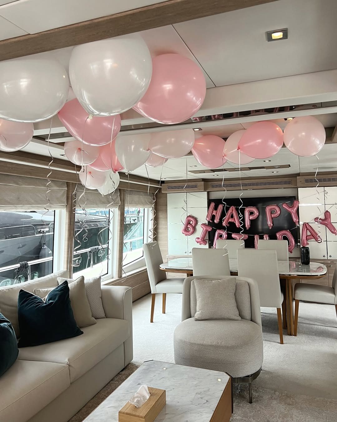 Pink balloon lounge setup for a bachelorette party on a yacht